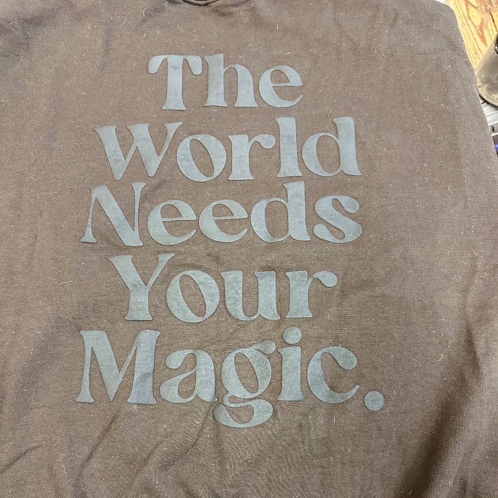 Brown Sweatshirt Large - World Needs Your Magic on back, smiley face on front